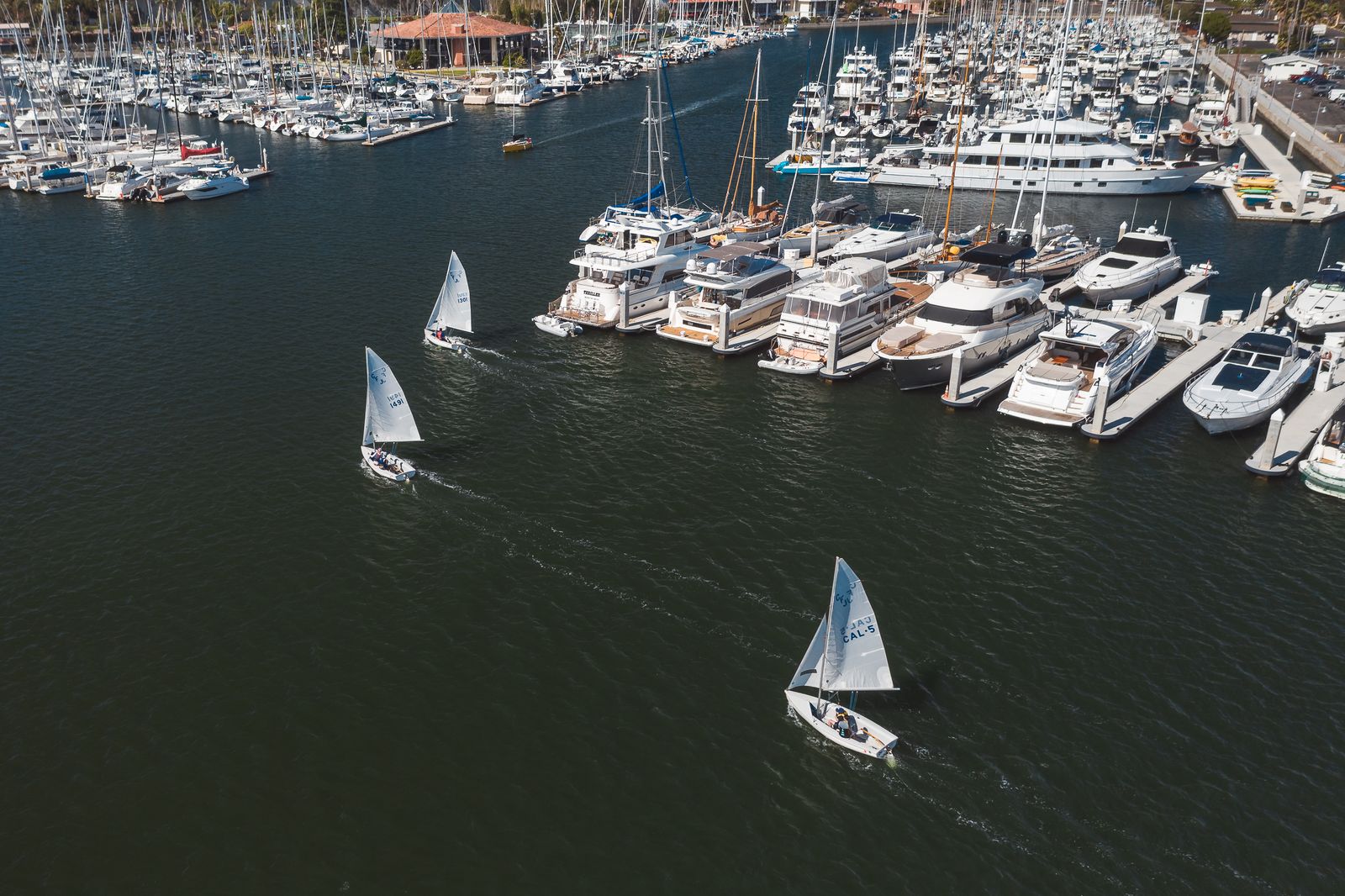 Aerial view of a marina packed with docked yachts and sailboats