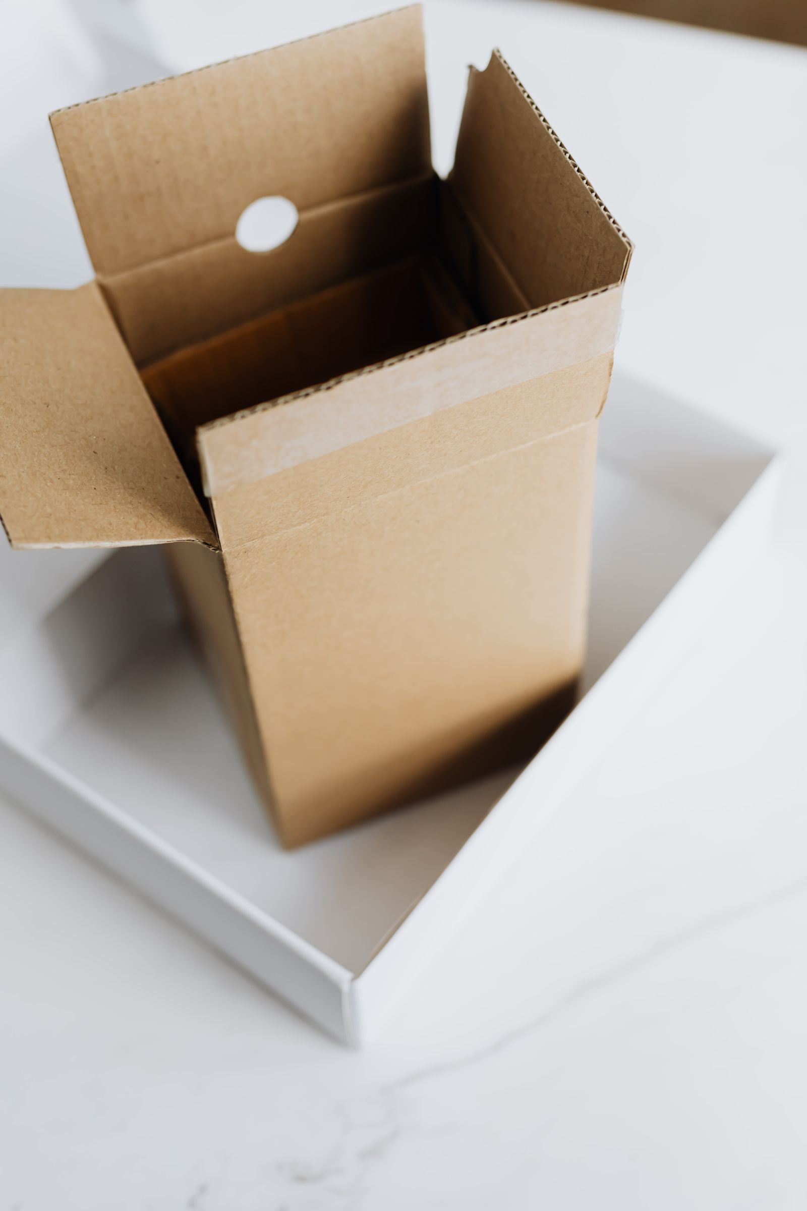 An open cardboard shipping box sitting inside a larger box, ready for a print-only wrap order