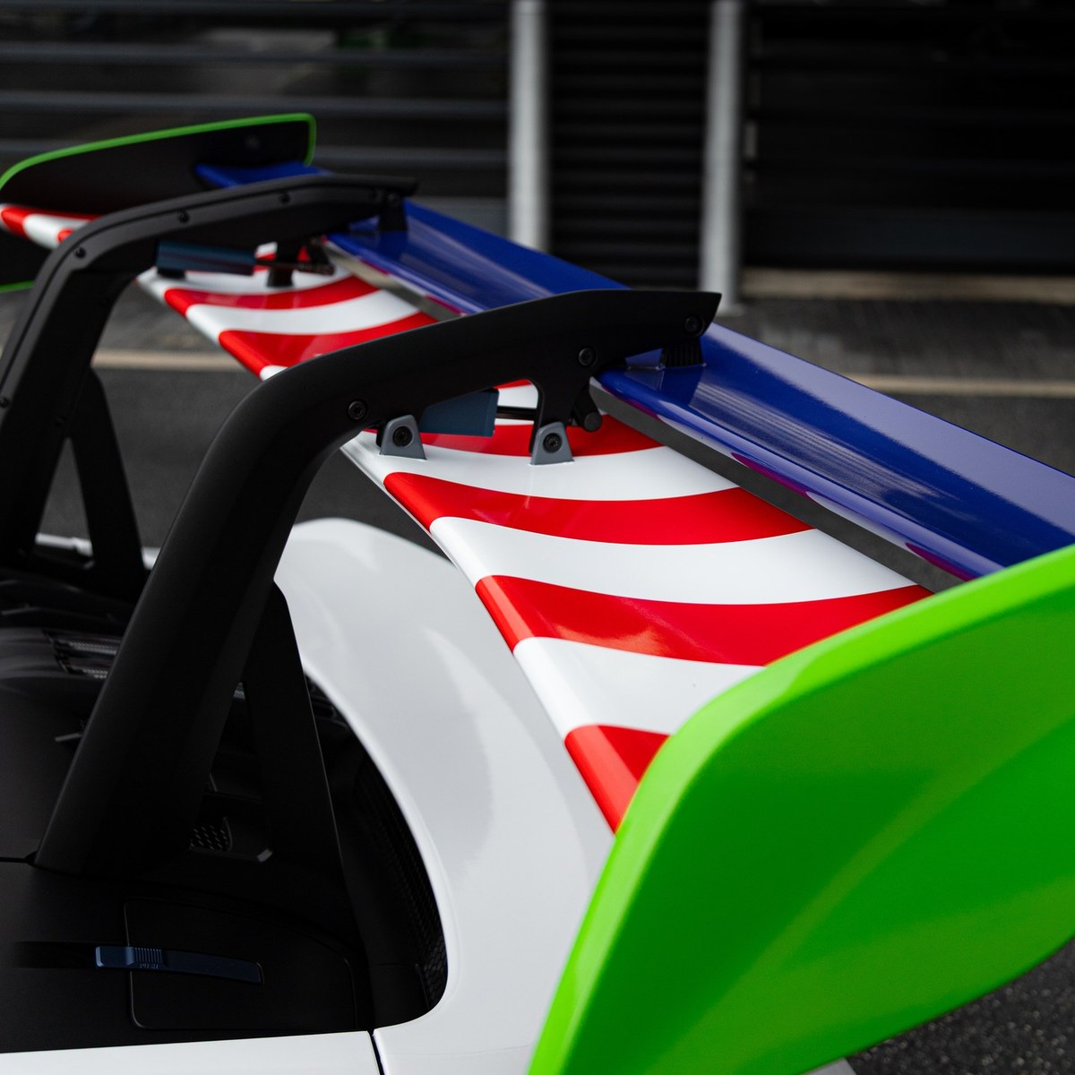 Macro detail of the color-blocked wing on the wrapped GT3 RS