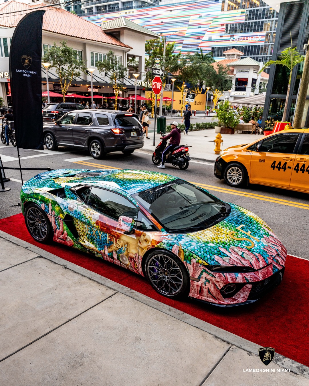 Sexy Fish art-wrapped Lamborghini Temerario on a red carpet on a Miami street corner